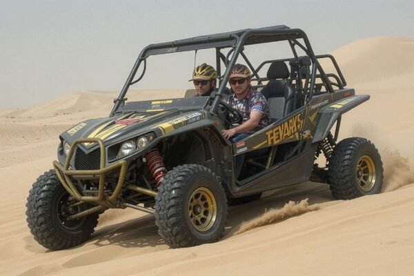 Two tourists riding a dune buggy through the desert during a Dubai Dune Buggy Tour, wearing safety helmets and enjoying the sandy terrain.