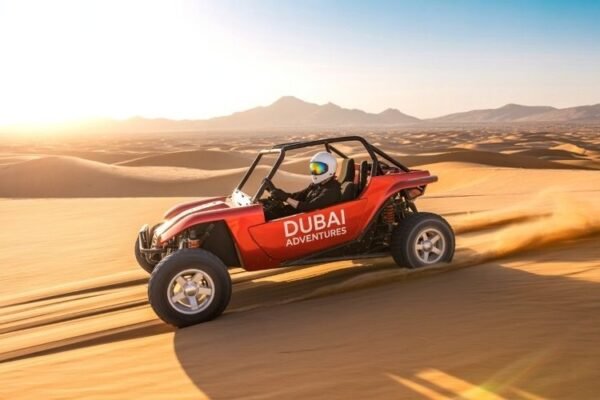 Self-drive dune buggy racing across golden desert dunes in Dubai during sunset