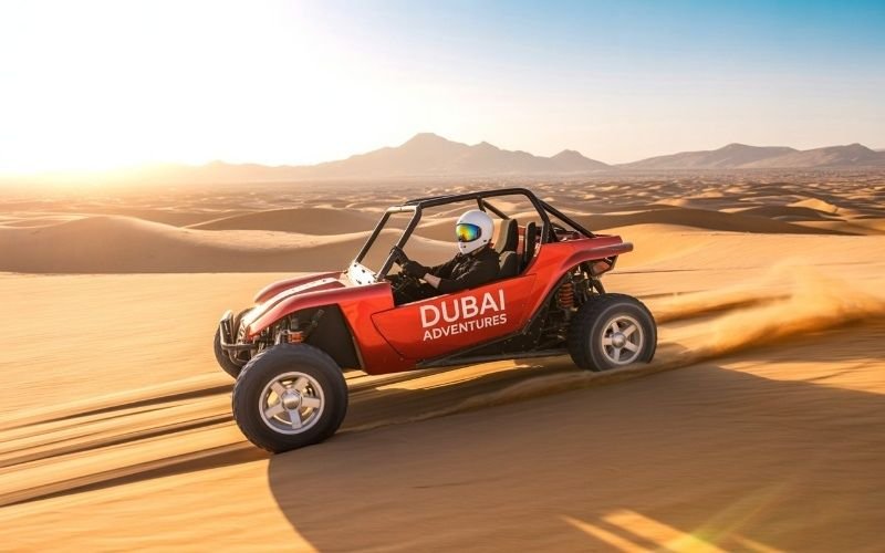 Self-drive dune buggy racing across golden desert dunes in Dubai during sunset