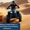 ATV riding in Dubai desert – rider on a quad bike speeding across golden sand dunes during an adventure.