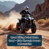 Quad biking on Dubai Hatta Road – rider on an ATV speeding through desert trails surrounded by mountains.