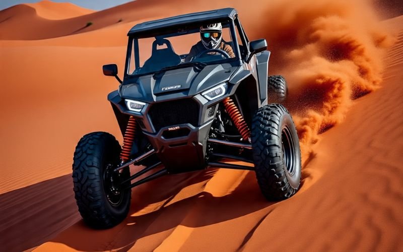 RZR vs Can-Am – high-performance off-road buggy racing across Dubai’s golden desert dunes, kicking up a trail of sand.