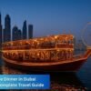Traditional dhow boat illuminated with warm lights, cruising along Dubai Marina at night with skyscrapers and the Ferris wheel in the background.