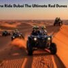 Tourists enjoying a 2 hour dune buggy ride across the red dunes of Dubai at sunset
