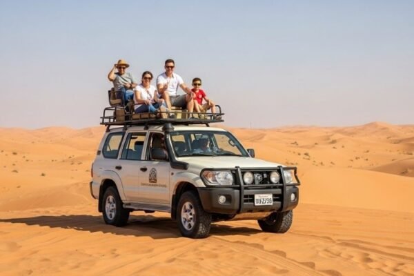 Group of people enjoying dune bashing on the red sand dunes in Dubai desert safari