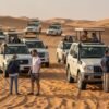 Group-pickup-desert-safari-Dubai-with-4x4-vehicles-driving-on-sand