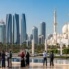 Abu-Dhabi-skyline-with-Sheikh-Zayed-Grand-Mosque,-tourists-exploring-city-attractions.