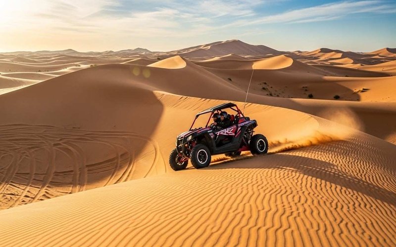 Al-Badayer-desert-in-Dubai-with-a-2-seater-buggy-riding-fast-over-open-sandy-dunes-perfect-for-adventure-seekers.