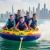 Family-enjoying-donut-ride-Dubai-water-sports-with-Dubai-Marina-skyline-in-the-background