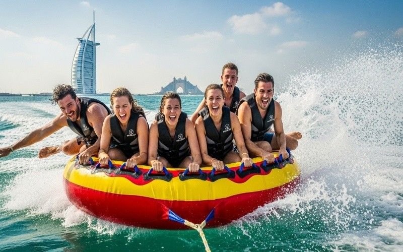 Friends-having-fun-on-an-inflatable-donut-ride-Dubai-water-sports-adventure