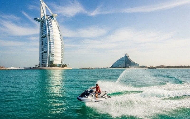 Jet-ski-riding-near-Burj-Al-Arab-hotel-on-Dubai’s-turquoise-waters-with-sunny-sky