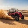 Red-2-seater-Polaris-dune-buggy-driving-over-golden-Dubai-desert-dunes-under-clear-blue-sky-adventurous-self-drive-desert-ride.