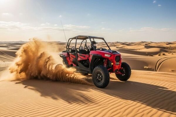 Red-2-seater-Polaris-dune-buggy-driving-over-golden-Dubai-desert-dunes-under-clear-blue-sky-adventurous-self-drive-desert-ride.