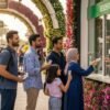 UAE residents at Dubai Miracle Garden ticket counter using UAE resident ticket Miracle Garden with Emirates ID for discounted entry and flower garden in background